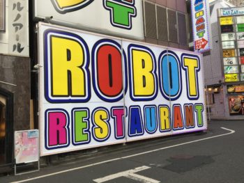 Colorful signage pointing the way to Robot Restaurant in Shinjuku