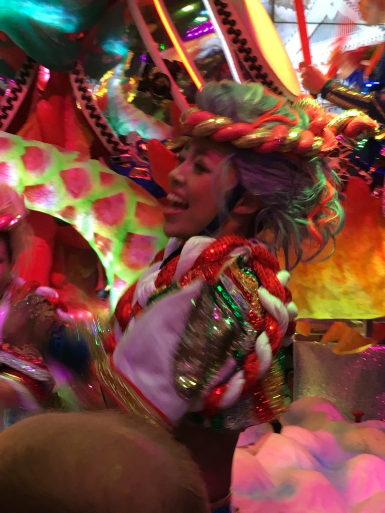 A slightly blurry picture of a smiling Japanese dancer