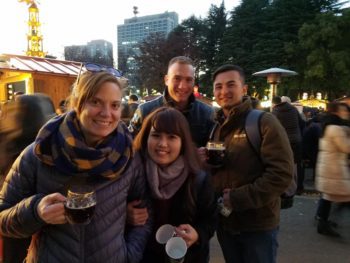 A group of 4 friends stands for a photo