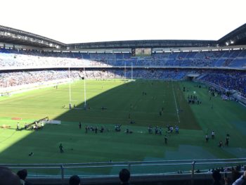 A large field with rugby players on the pitch