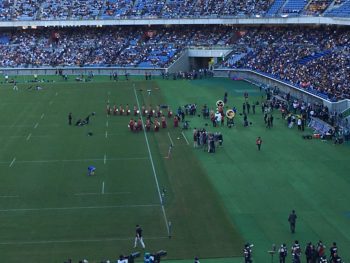A large field with rugby players on the pitch