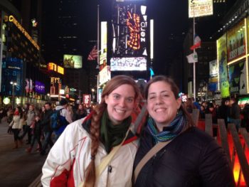 Two girls have their photo taken in Times Square, NYC