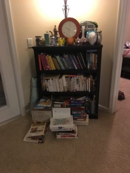 Books and breakable items are grouped together in a corner on moving day