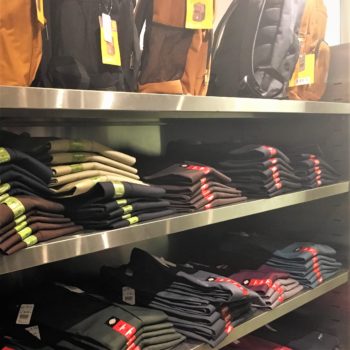 Raw Drip thrift store has both new and used clothing. Here are two shelves of jeans neatly folded for sale