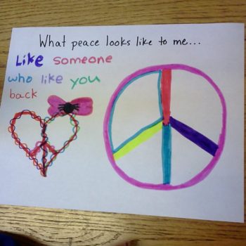 A student project on "what peace means to you." This student drew a piece sign within a heart shape and wrote "What peace looks like to you...like someone who likes you back"
